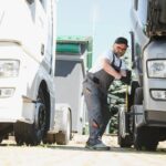 A senior worker checks wheel. Truck malfunction. Service work