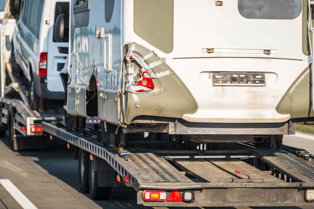 Damaged Camper Vans RV Towed Away to a Repair Shop