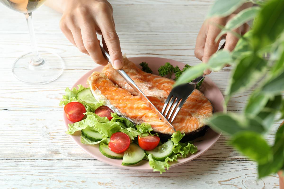Concept of tasty eating with grilled salmon, close up