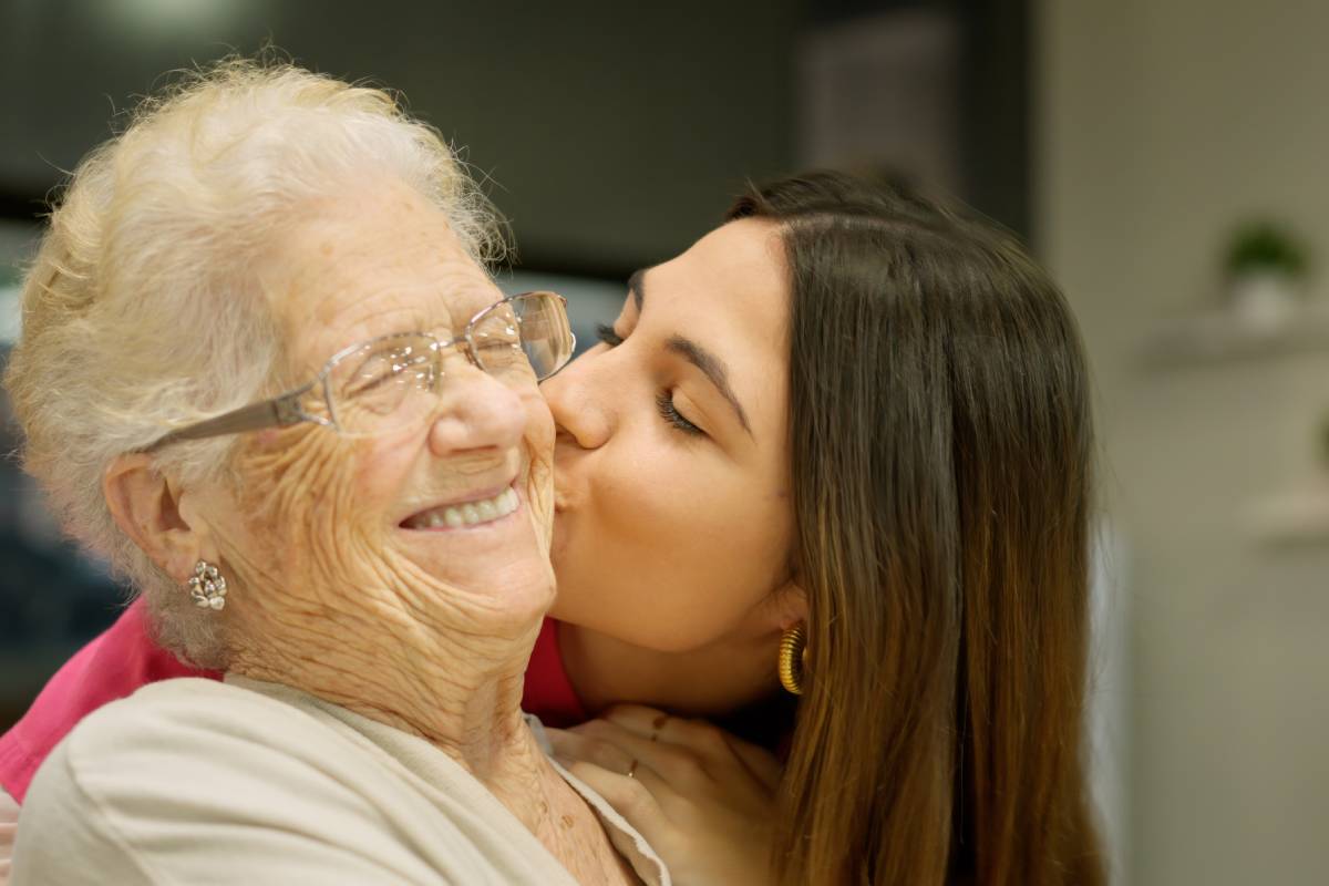Granddaughter kissing her grandmother with lots of love