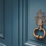 Door knocker on a blue wooden door A Complete Guide to Painting a Victorian Front Door: Colour Placement, Style Logic & Heritage Tips